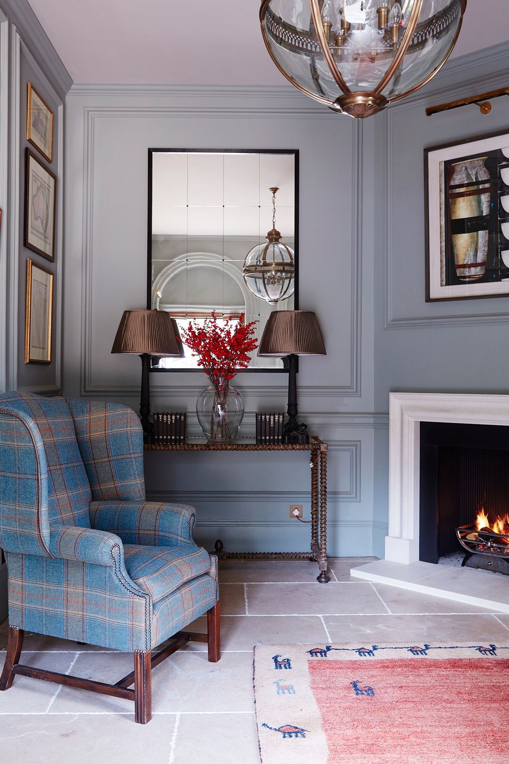 Image may contain Indoors Living Room Room Fireplace Furniture Interior Design Hearth and Chair