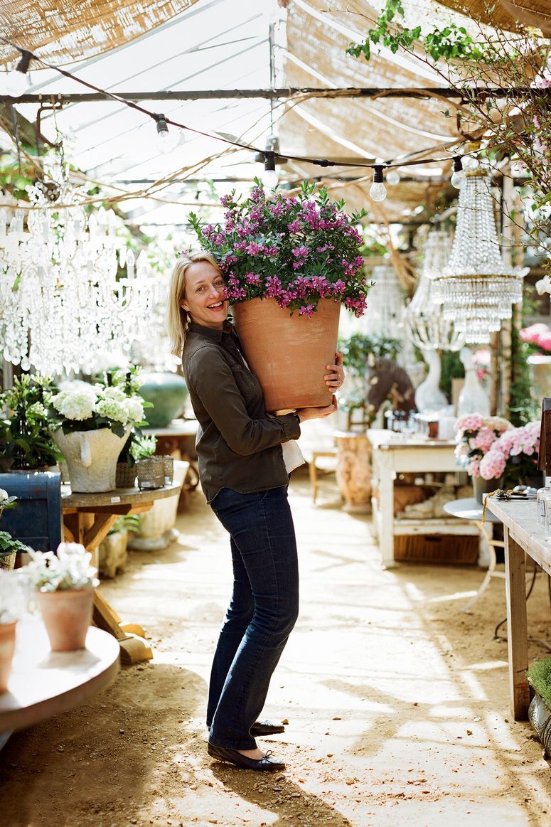 Image may contain: Human, Person, Plant, Clothing, Apparel, Footwear, Shoe, Flower, Blossom, Flower Arrangement, and Garden