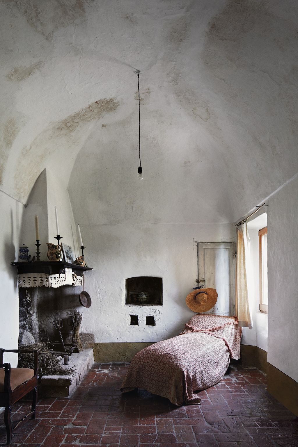 Image may contain Furniture Indoors Room Bedroom Interior Design Living Room Bed Fireplace and Hearth