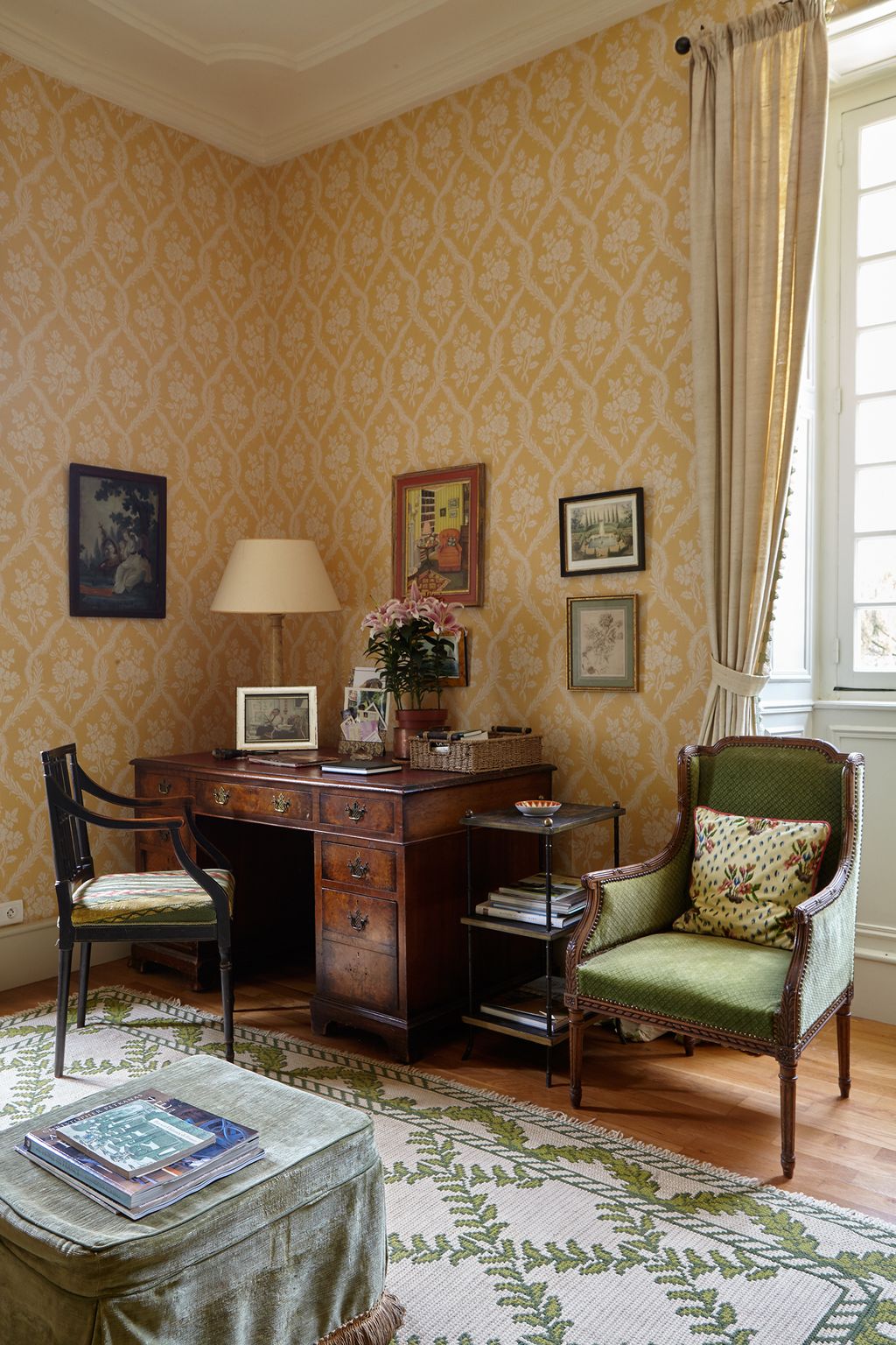 A discontinued Colefax wallpaper provides the backdrop for the desk that was a present from the firm on her retirement ...