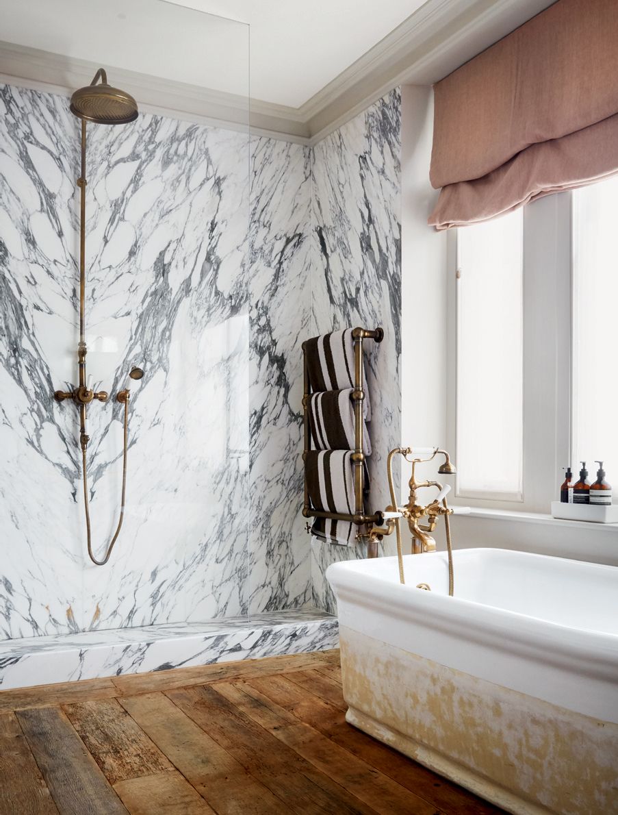 A marbleclad shower and a bath from a Paris flea market bring character to the bathroom.