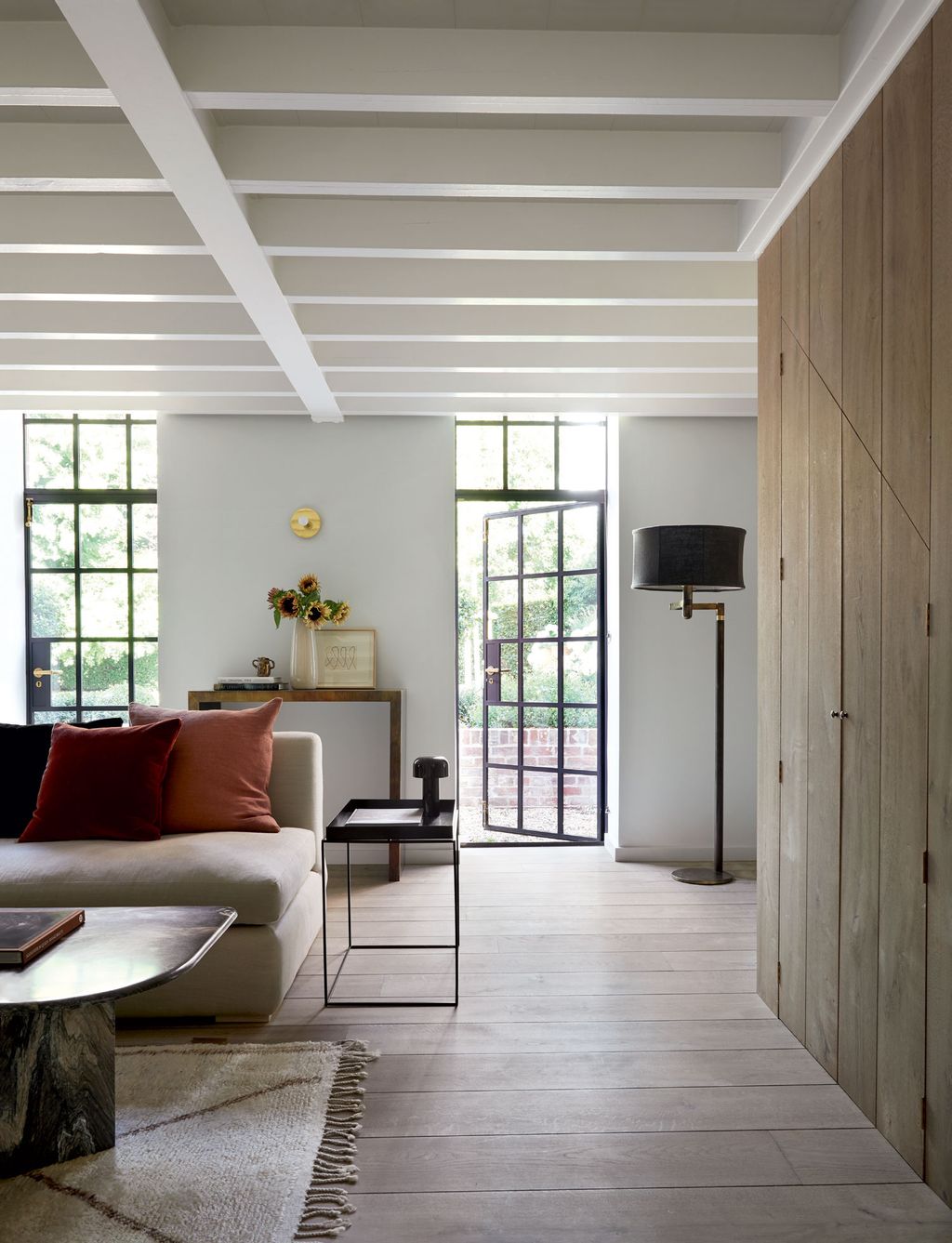 Image may contain Furniture Table Coffee Table Living Room Room Indoors Flooring Interior Design and Floor