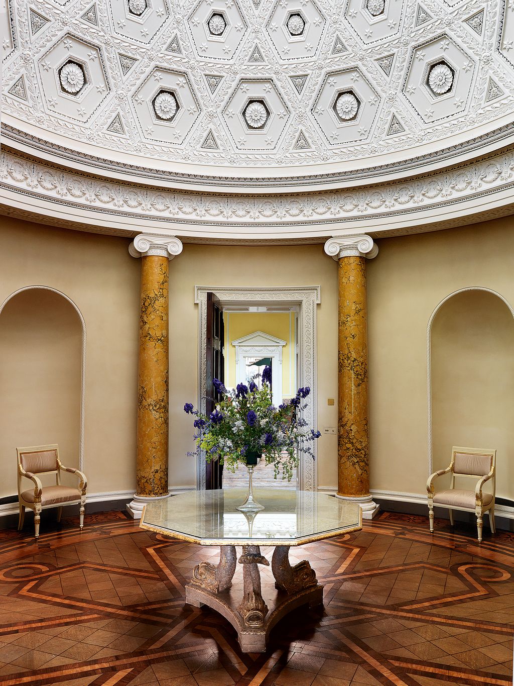 Image may contain Flooring Floor Lobby Room Indoors Living Room Interior Design Furniture Plant Flower and Blossom