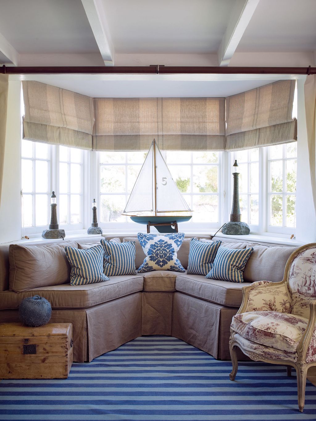 Decorative details such as the model boat and stone lighthouses in the drawing room were inspired by the coastal setting.