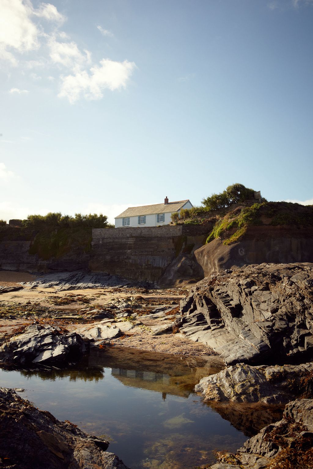 Image may contain Nature Outdoors Promontory Water Ocean Sea Shoreline Building Architecture Cliff Tower and Land