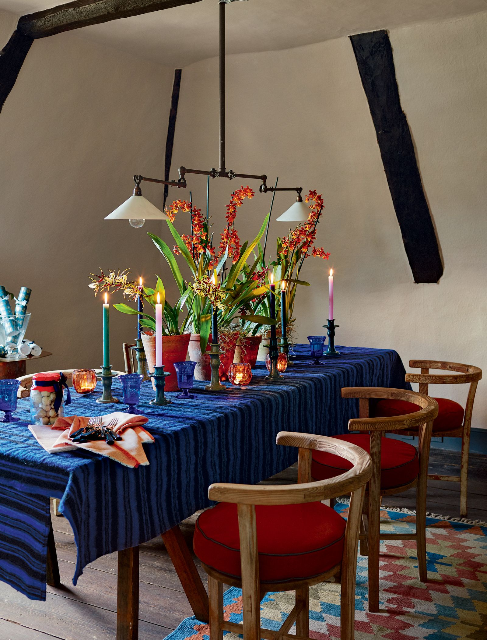 Image may contain Furniture Chair Home Decor Plant Indoors Interior Design Human Person Tablecloth and Flower