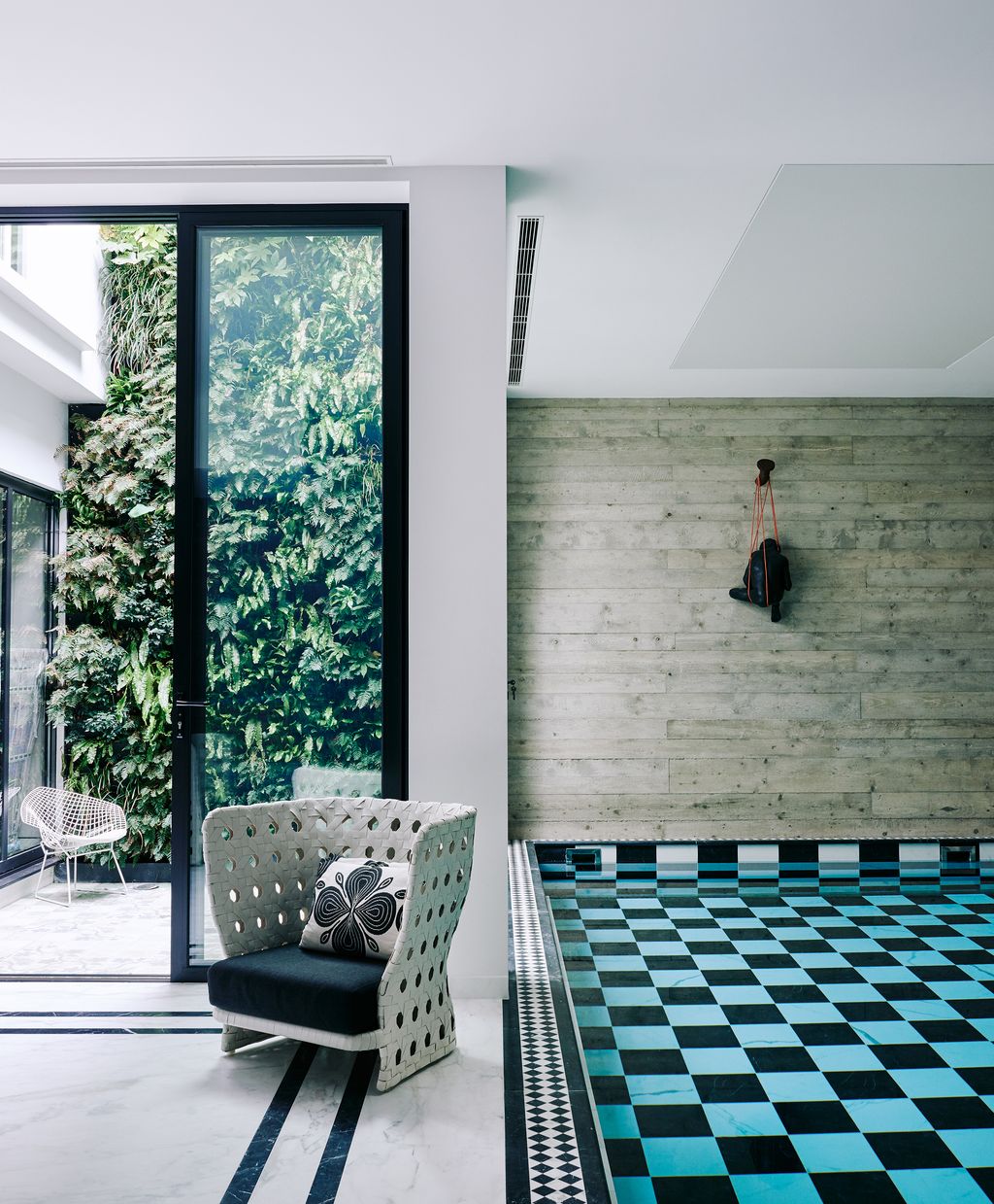 Extra space was created in the basement for a pool. A ‘Canasta outdoor armchair from BB Italia resides beside it. Its...