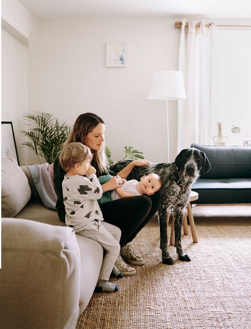 Image may contain Furniture Couch Living Room Indoors Room Human Person Animal Pet Canine Dog and Mammal