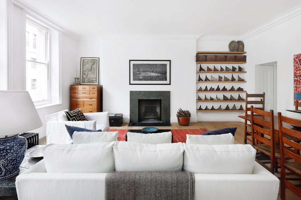 Image may contain Living Room Room Indoors Interior Design Furniture Couch and Fireplace