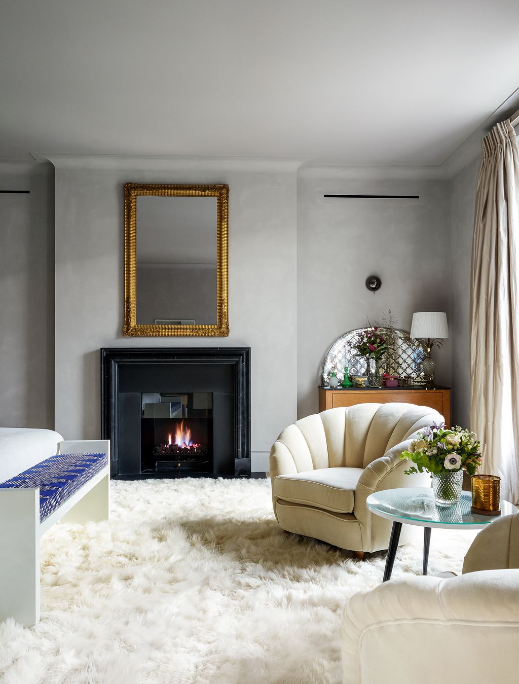 Image may contain Indoors Living Room Room Fireplace Rug Hearth Furniture Home Decor and Couch