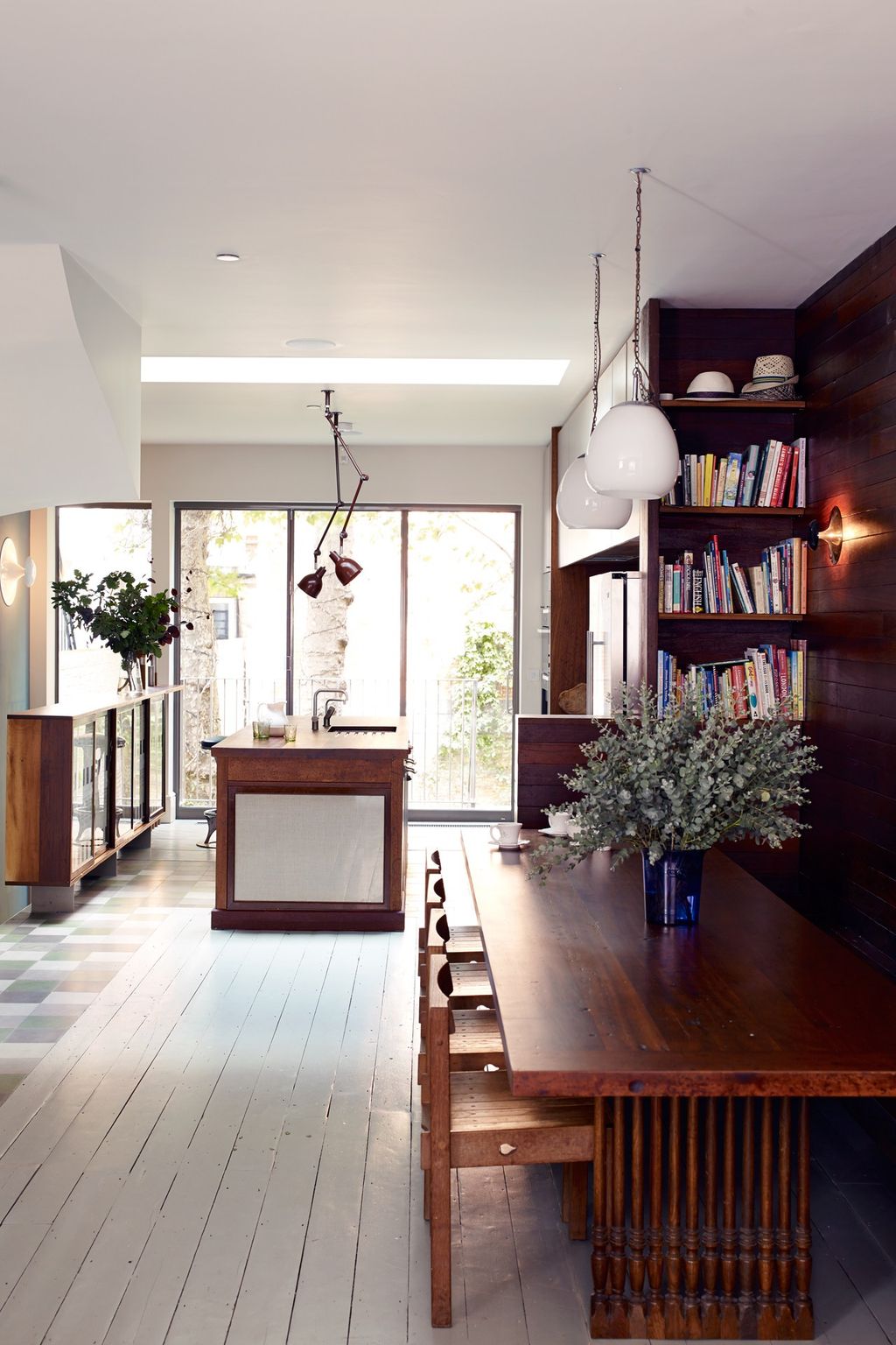 Image may contain Flooring Wood Hardwood Floor Furniture Living Room Room Indoors Interior Design and Bookcase