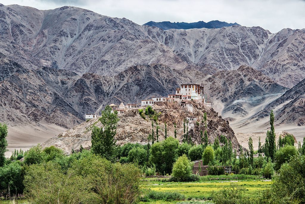 Image may contain Nature Outdoors Mountain Housing Architecture Building Monastery Scenery and Mountain Range