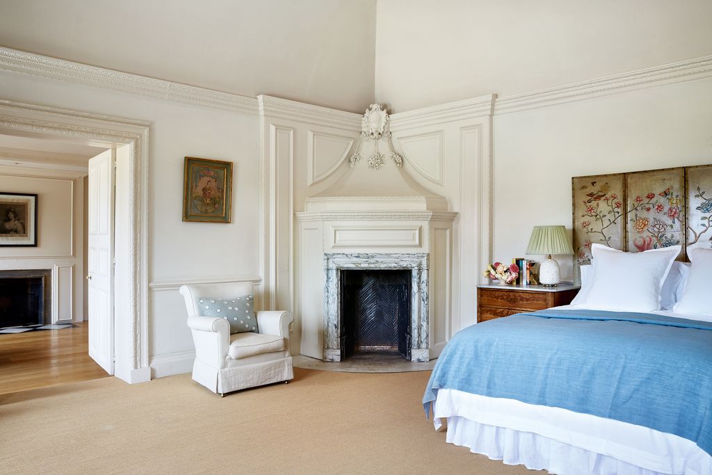 Image may contain Furniture Indoors Room Fireplace Living Room Interior Design Hearth Bed Home Decor and Bedroom