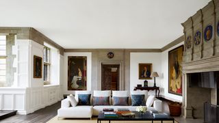 Image may contain Living Room Room Indoors Furniture Flooring Couch Interior Design Table Rug and Coffee Table