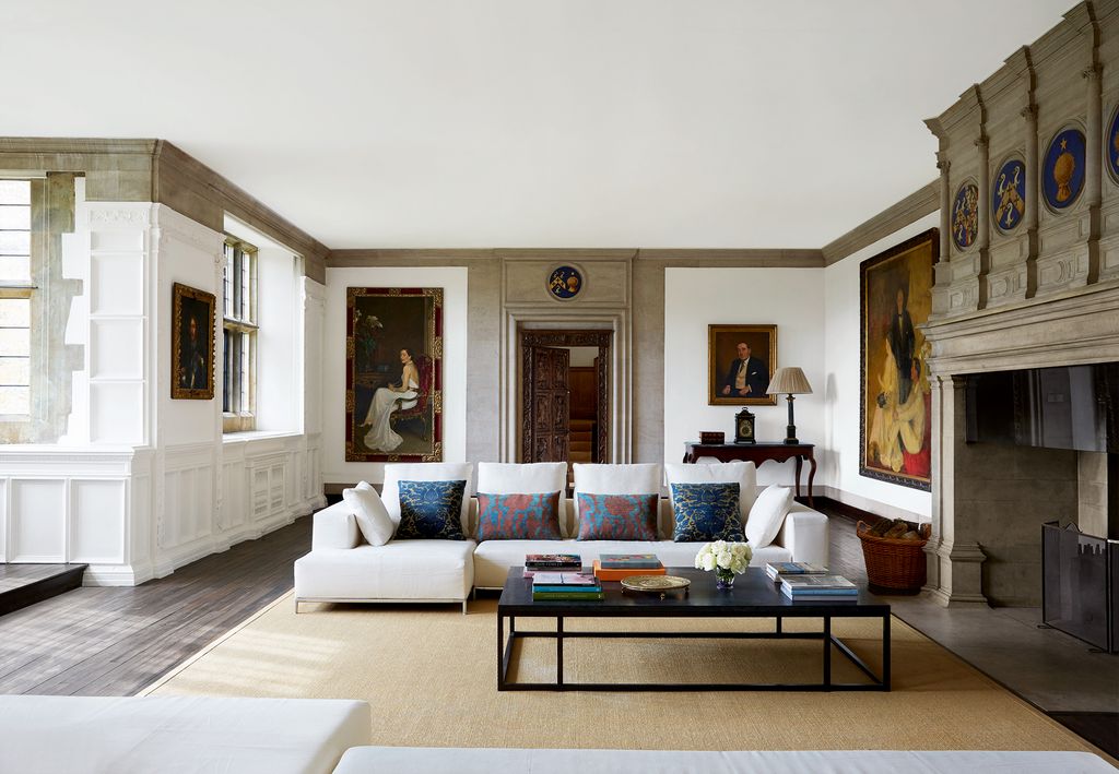 Image may contain Living Room Room Indoors Furniture Flooring Couch Interior Design Table Rug and Coffee Table