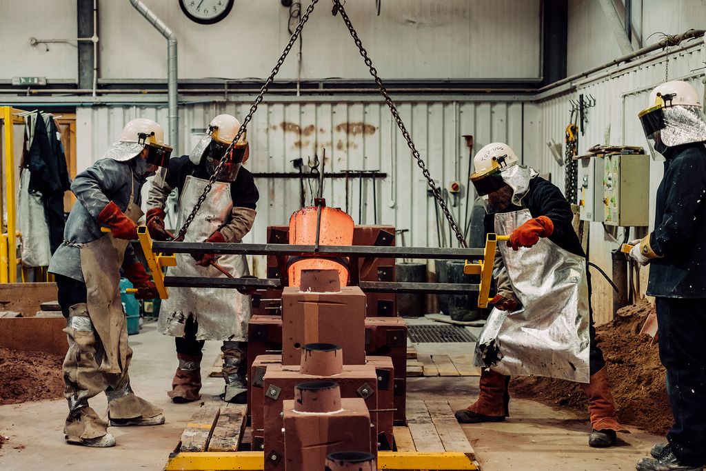 Farquhar with Black Isle Bronze employees Piotr and Robin pouring bronze.