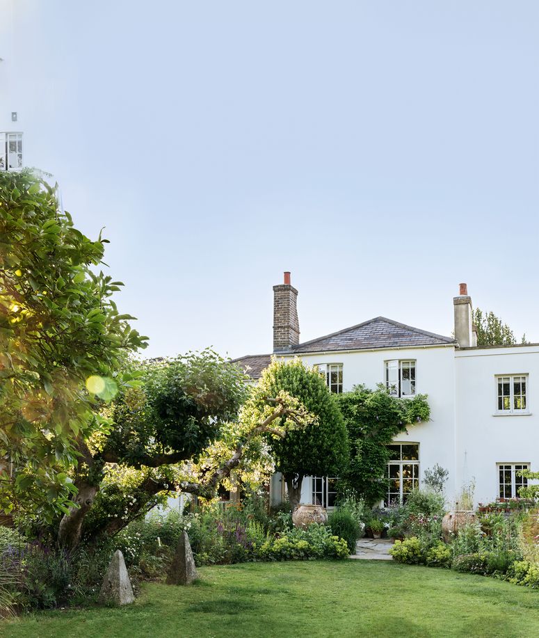 Image may contain: Grass, Plant, Outdoors, Building, Housing, Garden, Cottage, House, Villa, and Arbour