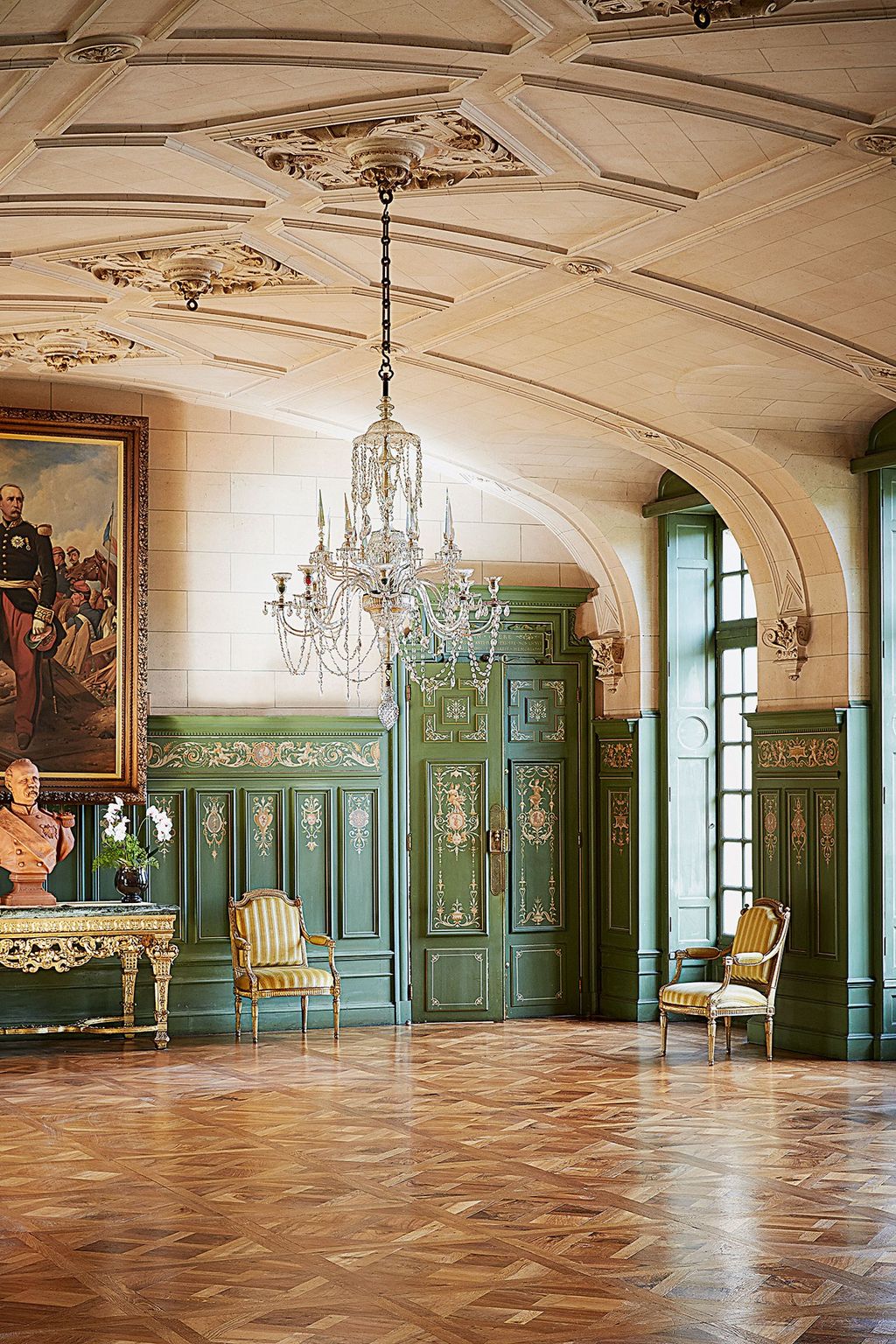 The ceiling and decorative panelled walls in russian green set a grand tone in the ballroom at the Château de Sully. ...