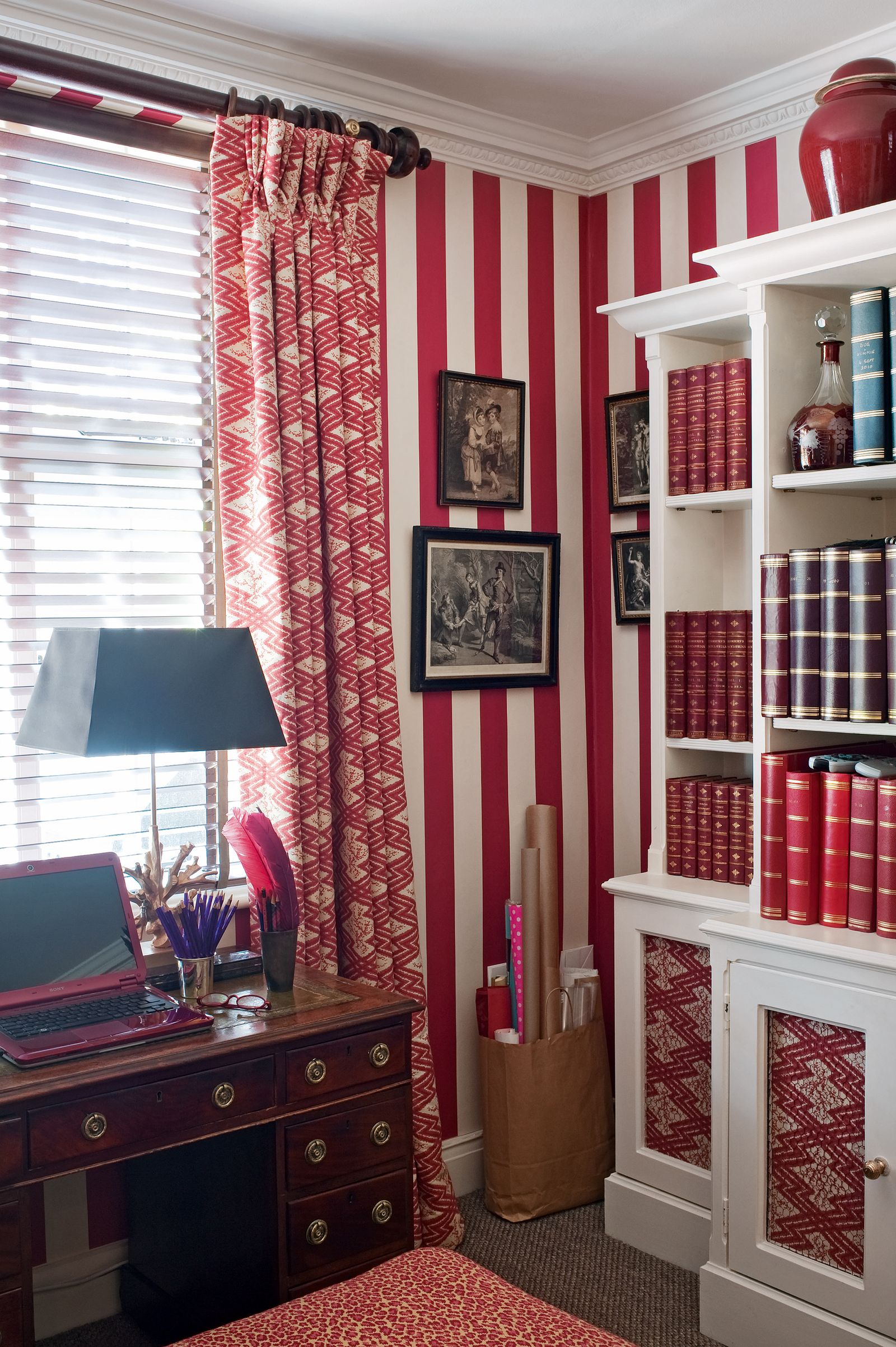 Image may contain Furniture Shelf Electronics Computer Laptop Pc Bookcase Room Indoors Lamp and Table Lamp