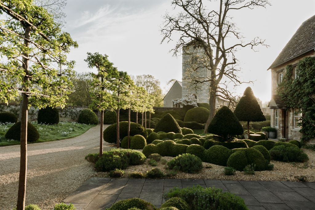 Image may contain Plant Grass Outdoors Tree Hedge Fence and Garden