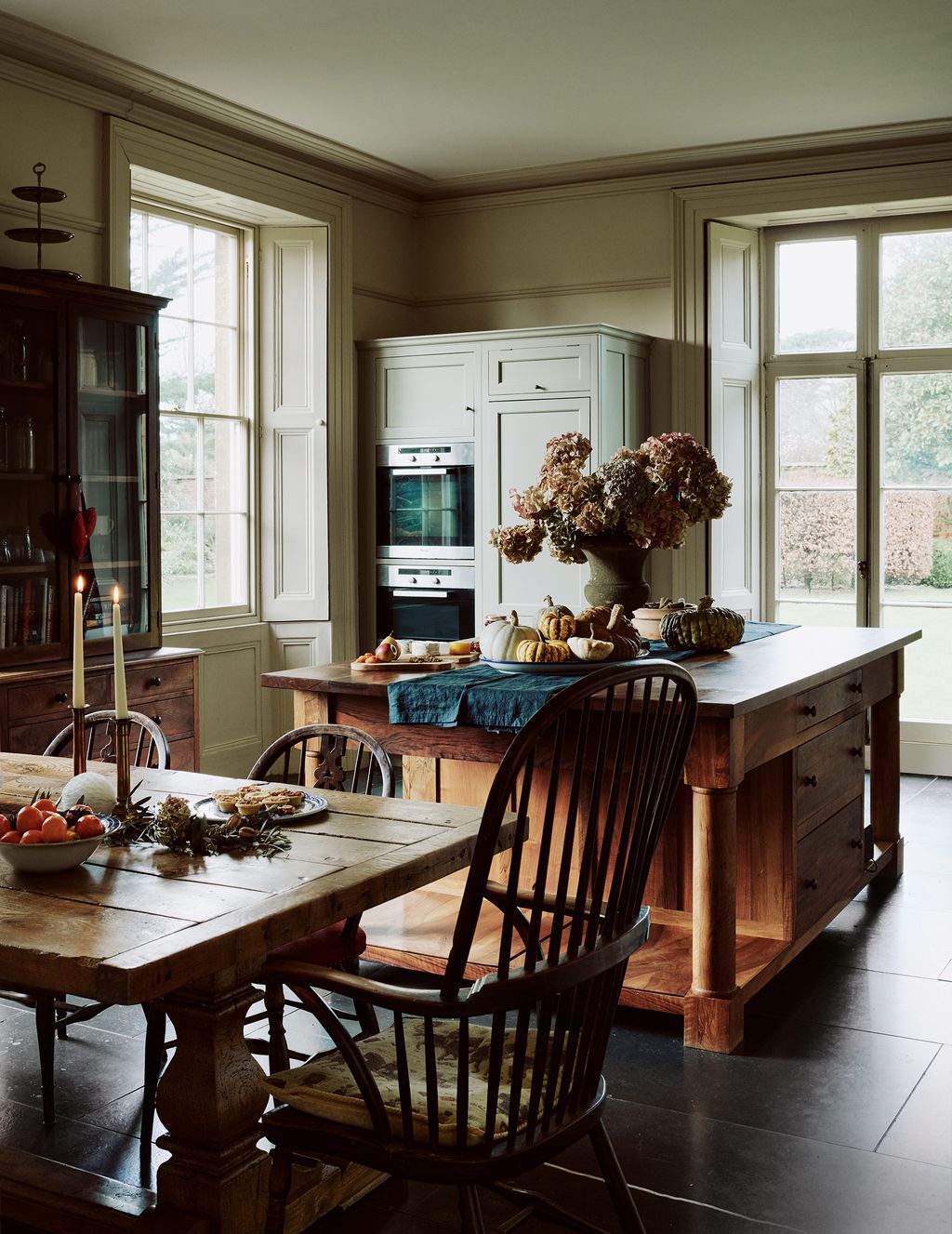 Image may contain Furniture Chair Wood Room Indoors Hardwood Dining Table Table Plant and Flooring