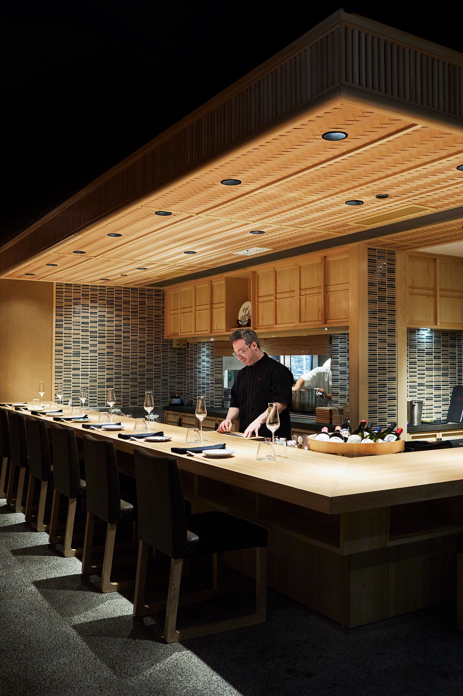 Image may contain Human Person Restaurant Wood Plywood Cafeteria Kitchen Island and Indoors