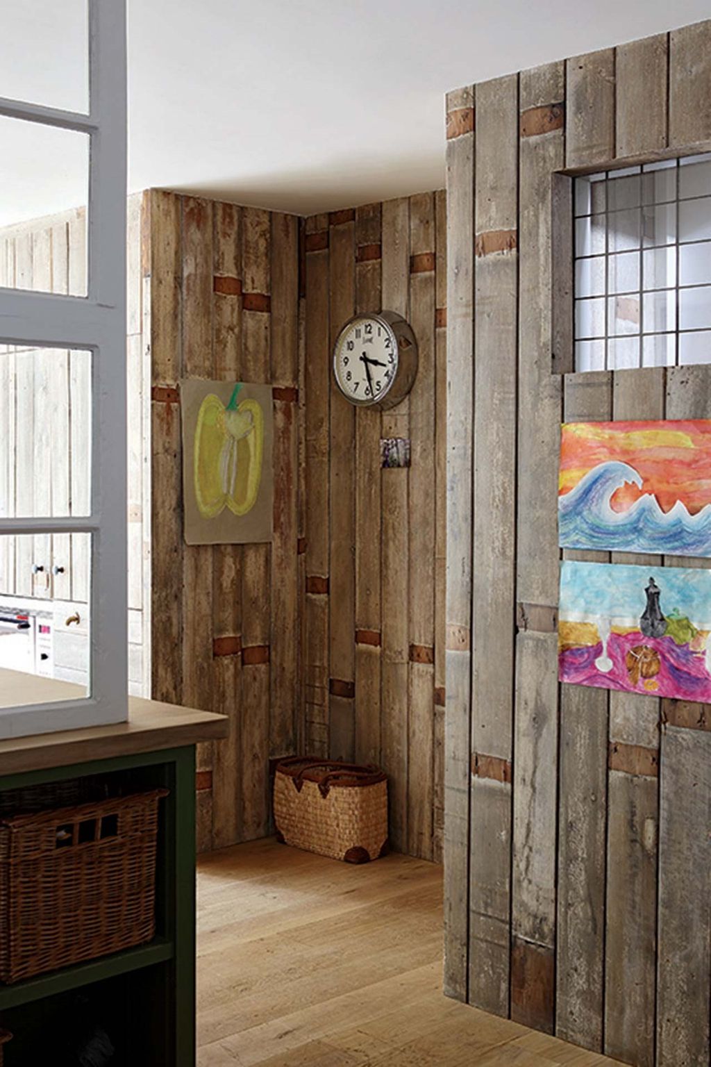 A wood panelled wall leads into the kitchen.