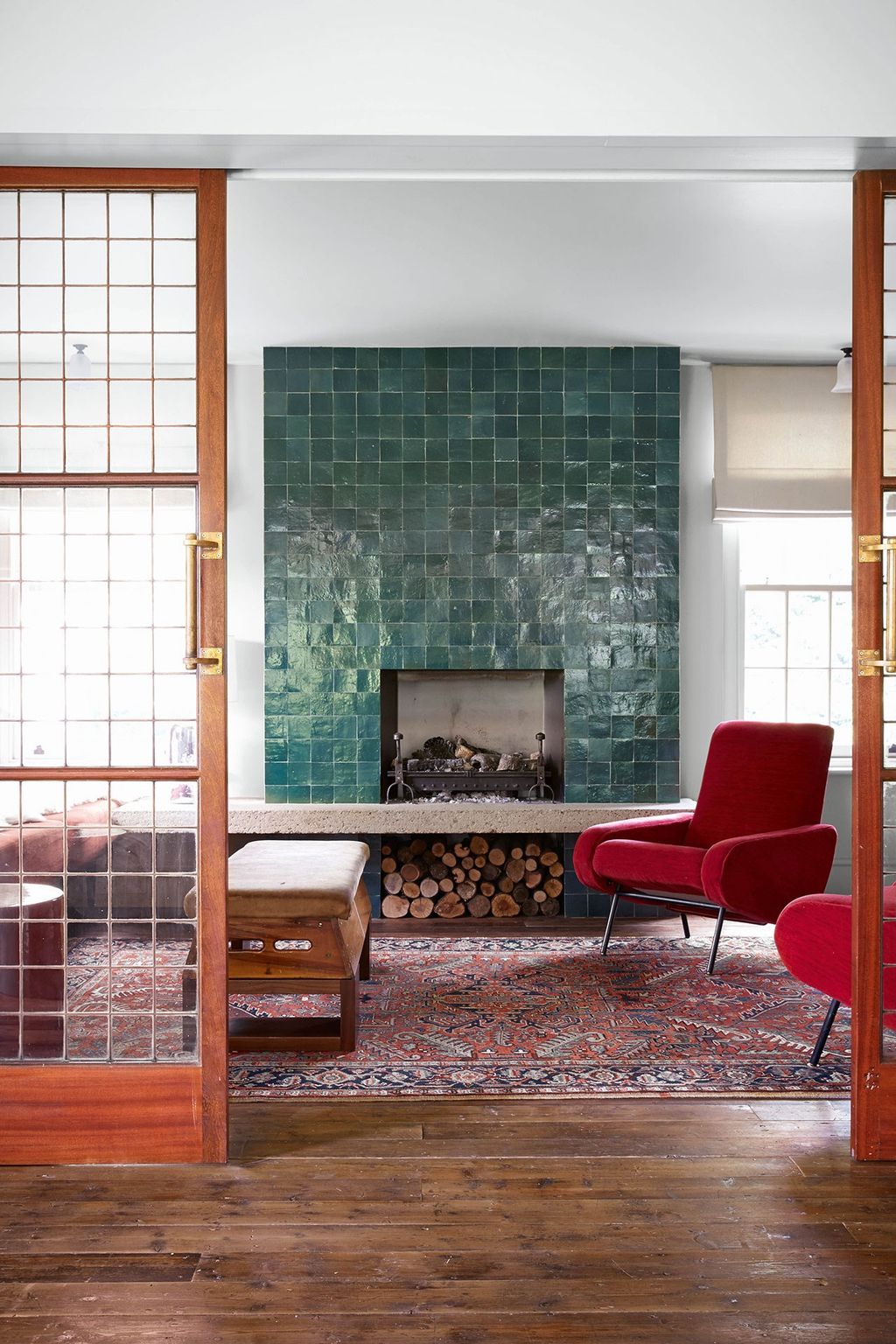 Image may contain Furniture Chair Fireplace Indoors Interior Design Hearth Living Room Room and Rug