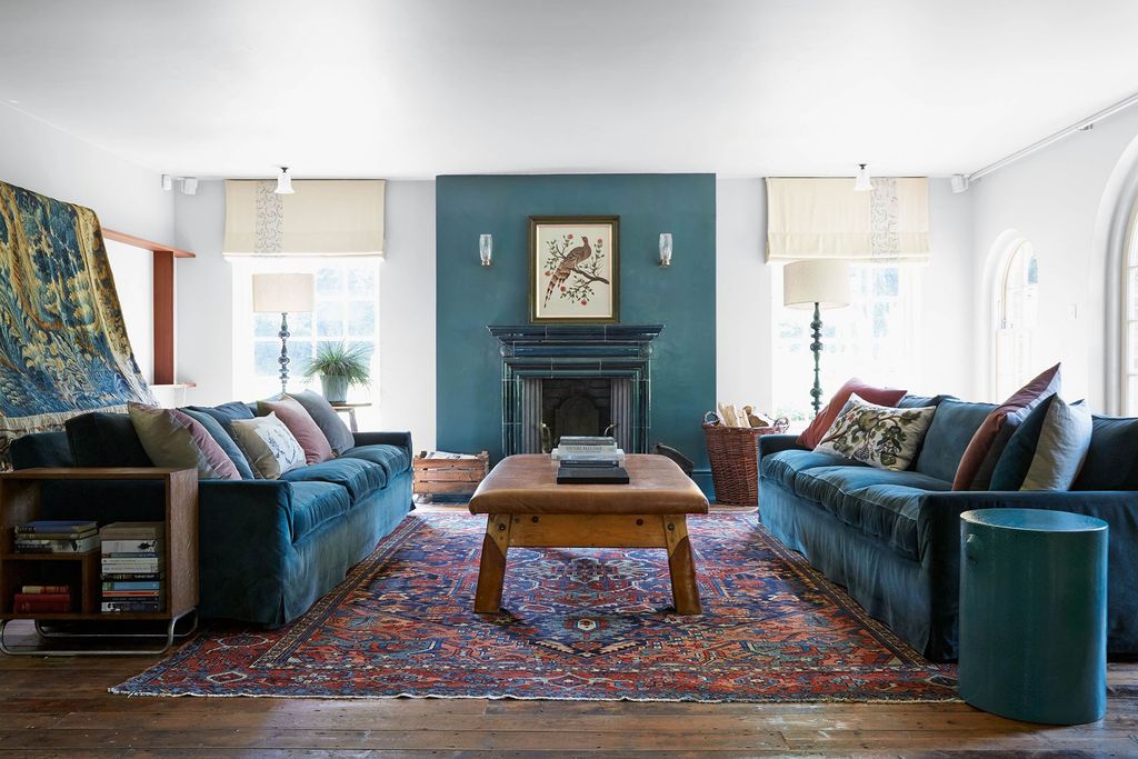 Image may contain Living Room Room Indoors Furniture Couch Rug Flooring and Interior Design