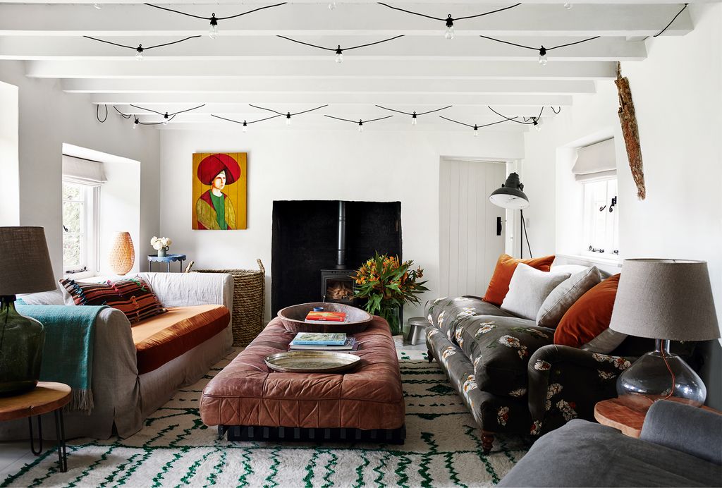 Image may contain Living Room Room Indoors Furniture Couch Interior Design Rug and Table