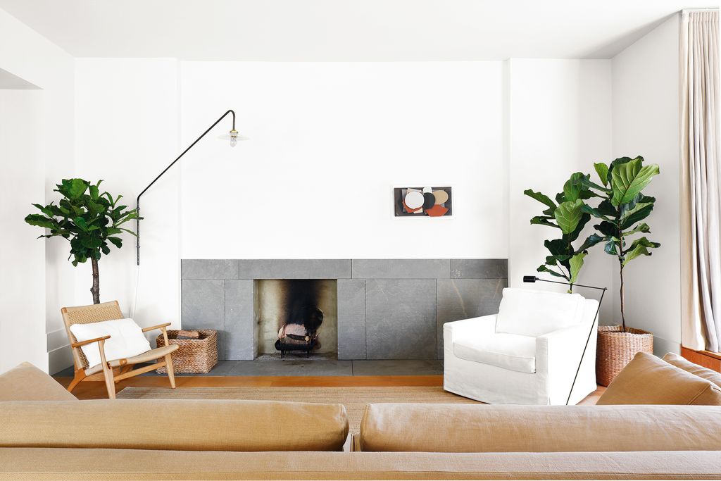 Image may contain Living Room Room Indoors Furniture Interior Design Fireplace Table Couch Hearth and Coffee Table