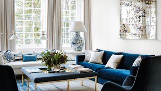 Image may contain Furniture Living Room Room Indoors Chair Couch Table Rug Coffee Table Lamp and Chandelier