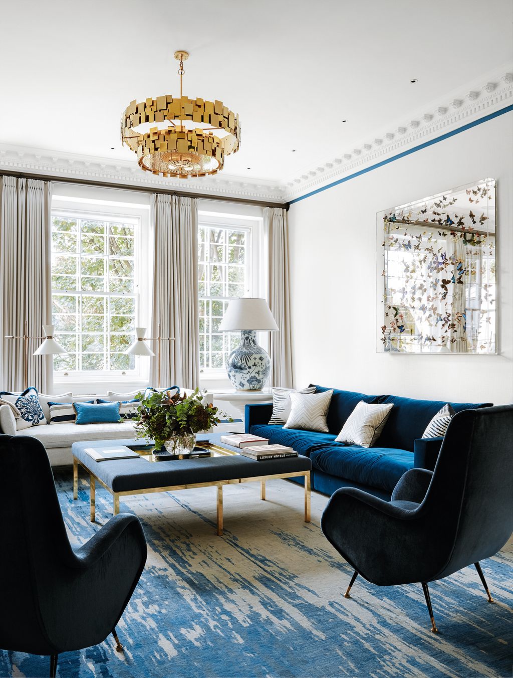 Image may contain Furniture Living Room Room Indoors Chair Couch Table Rug Coffee Table Lamp and Chandelier