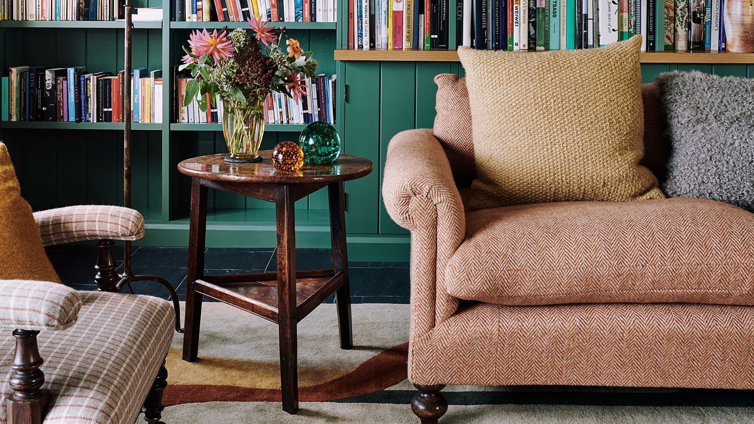 Image may contain: Furniture, Bookcase, Indoors, Room, Living Room, Rug, Library, and Book