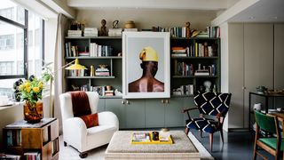 Image may contain Furniture Living Room Room Indoors Shelf Bookcase Chair Interior Design Table and Couch