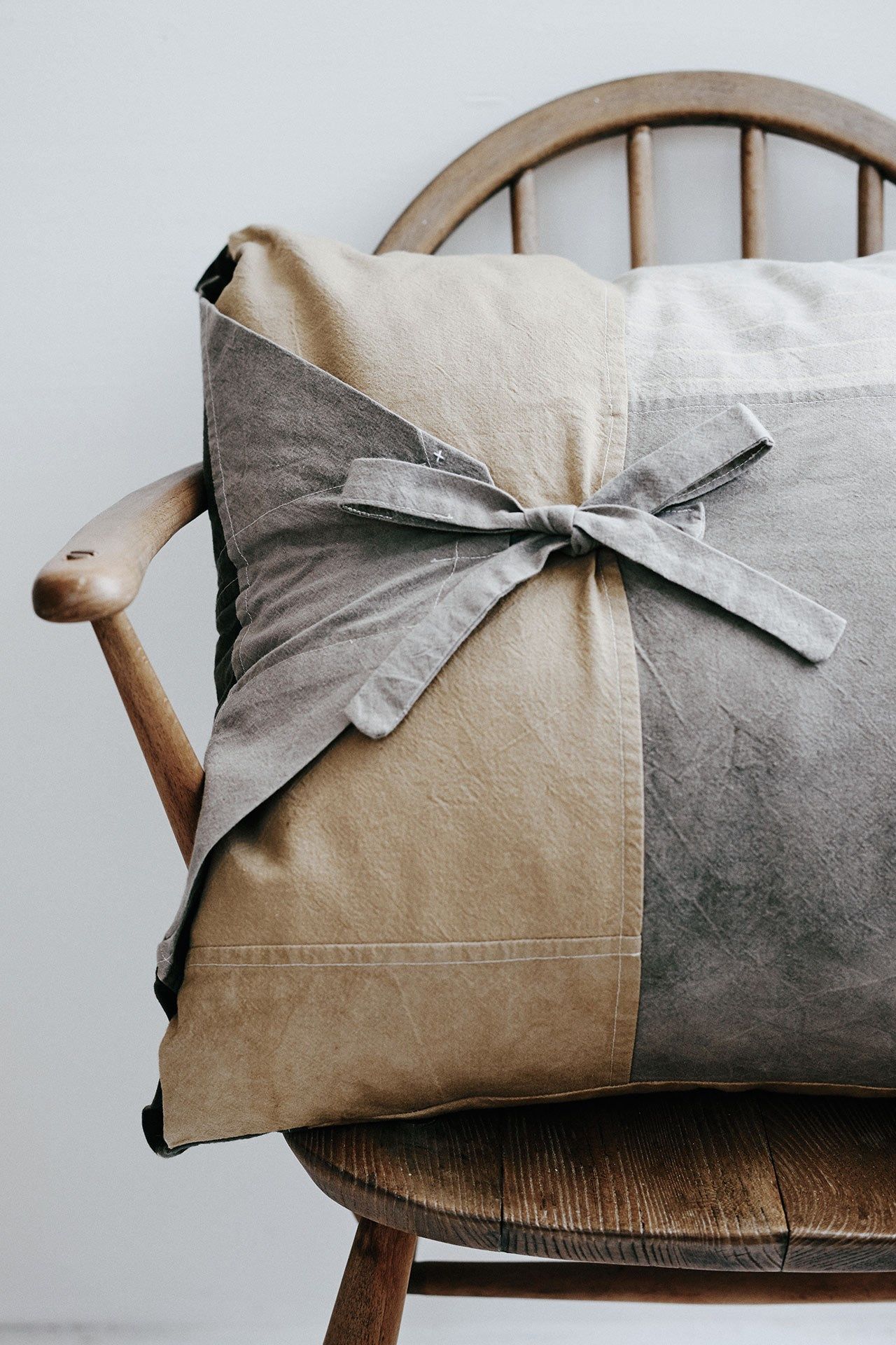 Image may contain Home Decor Cushion Pillow Linen Furniture and Chair