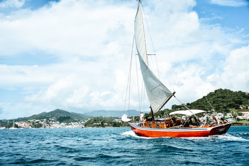 Image may contain Vehicle Transportation Boat Vessel Watercraft Human Person and Sailboat