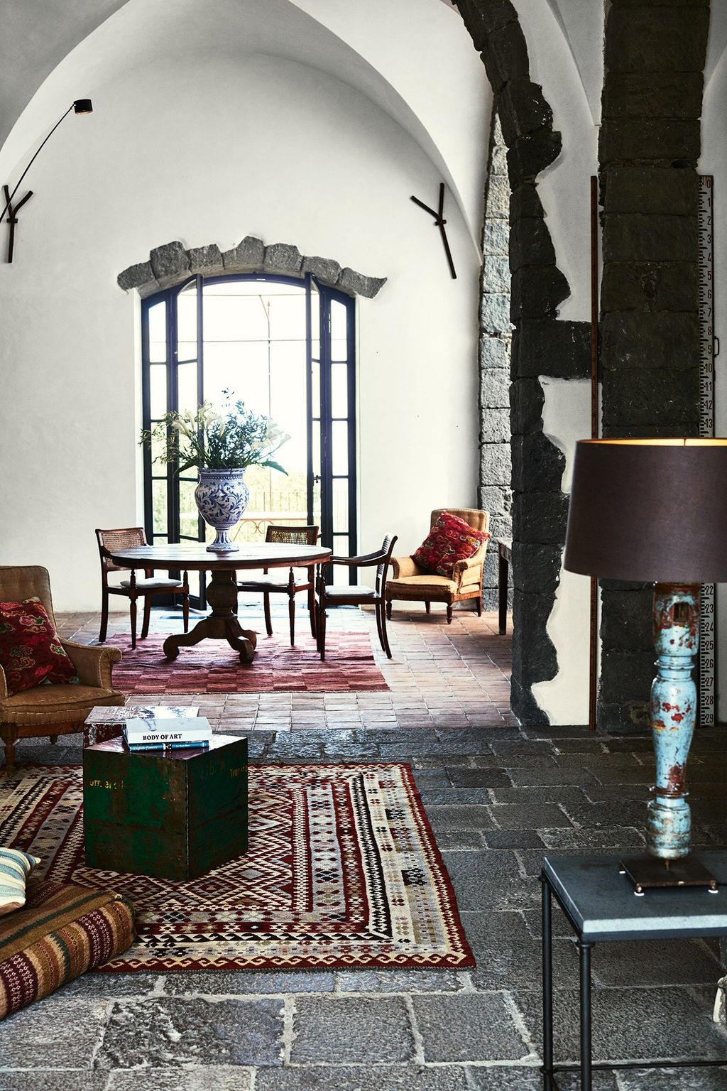 Image may contain Living Room Room Indoors Furniture Lamp Table Lamp Chair and Rug