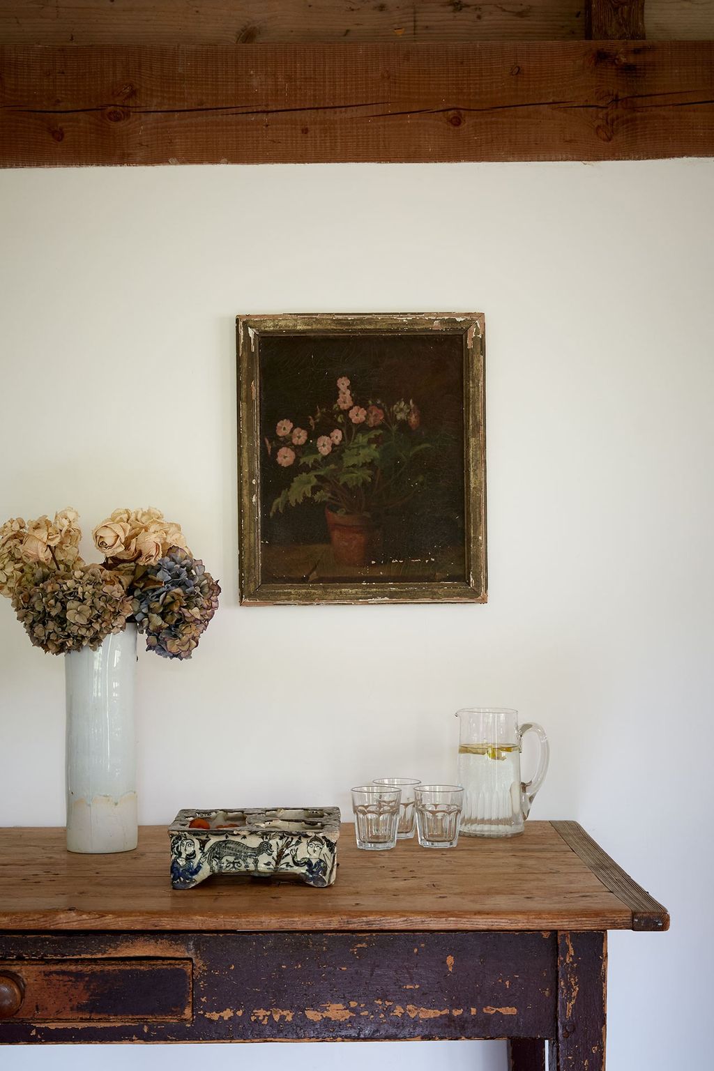 Antique wooden hall table and white walls in a country hallway belonging to Max Rollitt. Hallway Design Ideas furniture...