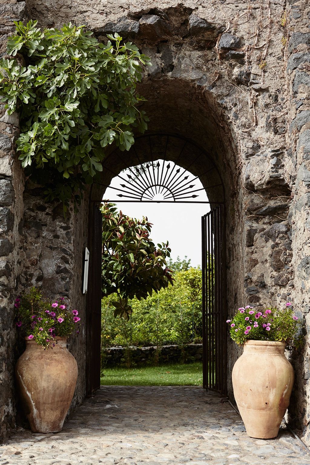 Image may contain Garden Outdoors Arbour Flagstone Plant and Patio