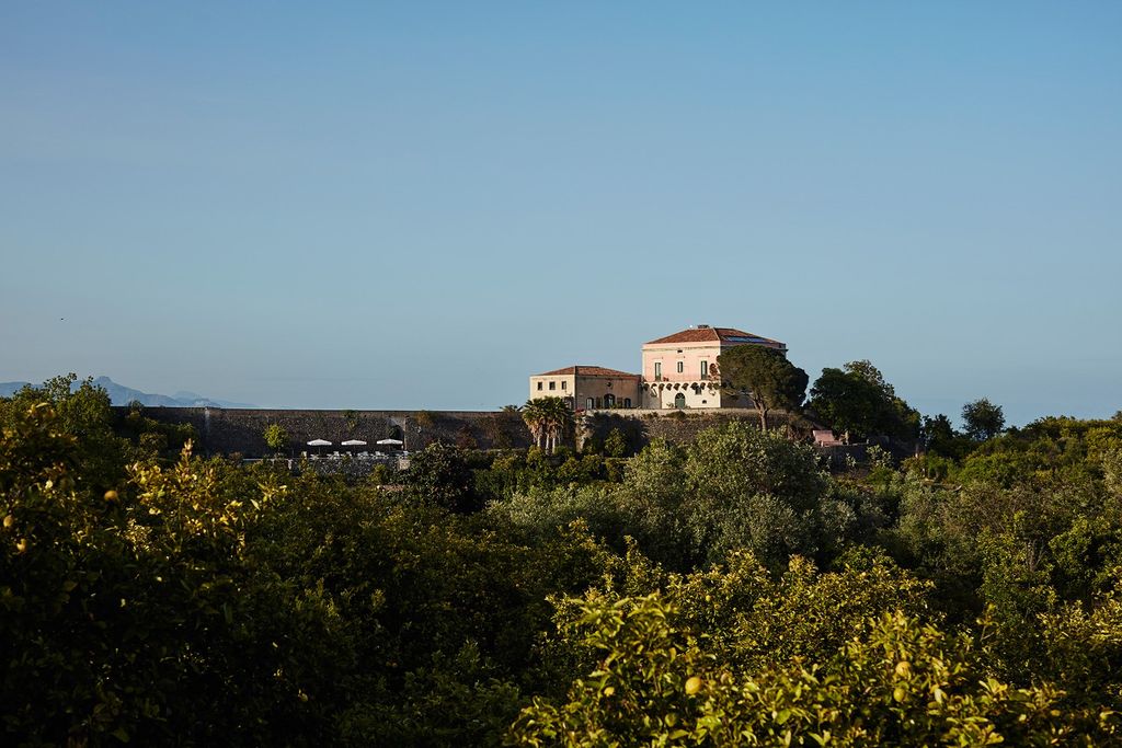 Image may contain Nature Outdoors Vegetation Plant Scenery Architecture Building Landscape Land and Tree