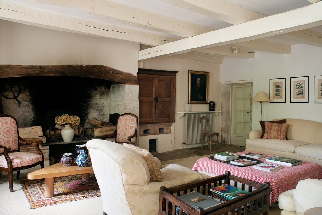 Image may contain Living Room Room Indoors Furniture Couch Wood Chair Flooring Hardwood and Interior Design