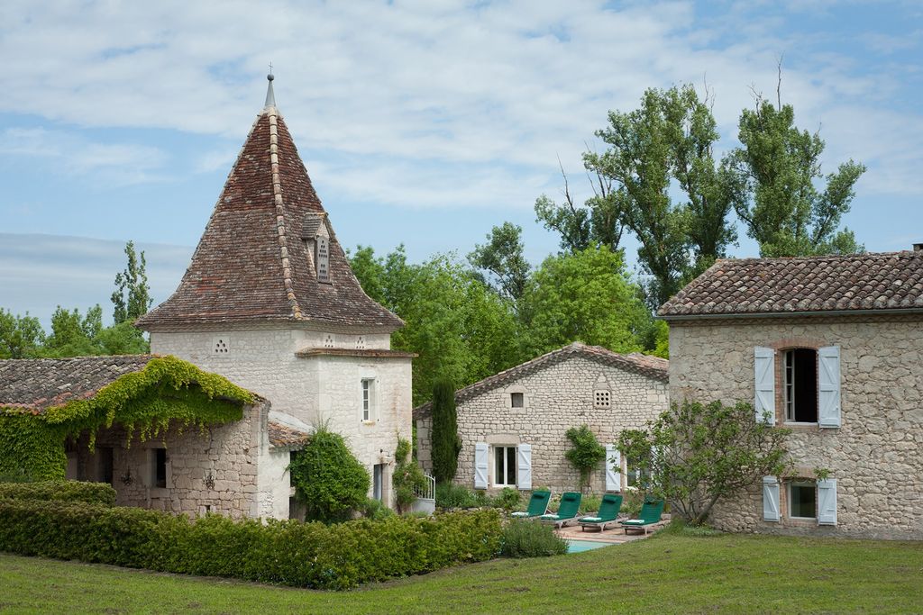 A view of the barns from the back garden which contain the guest bedrooms behind the planting is the swimming pool.