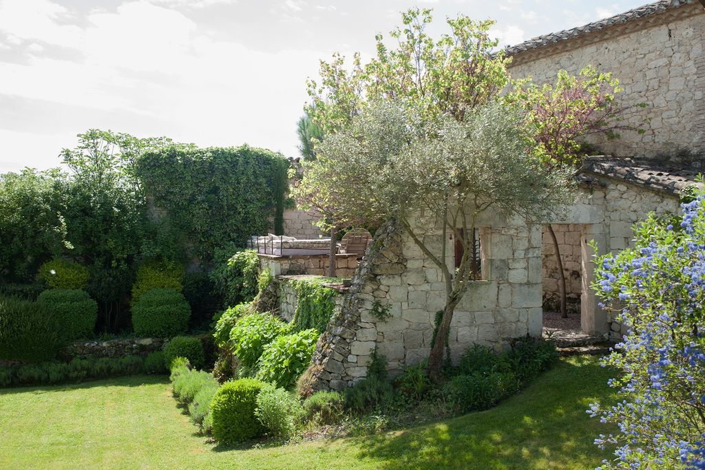The shell of an outbuilding has been repurposed to contain an outdoor sitting area.