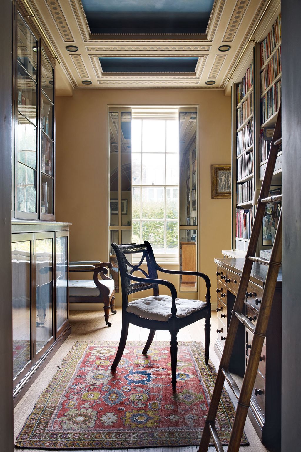 Oak and ebony bookshelves inspired by the work of George Bullock a Regency designer give a masculine feel to this study...