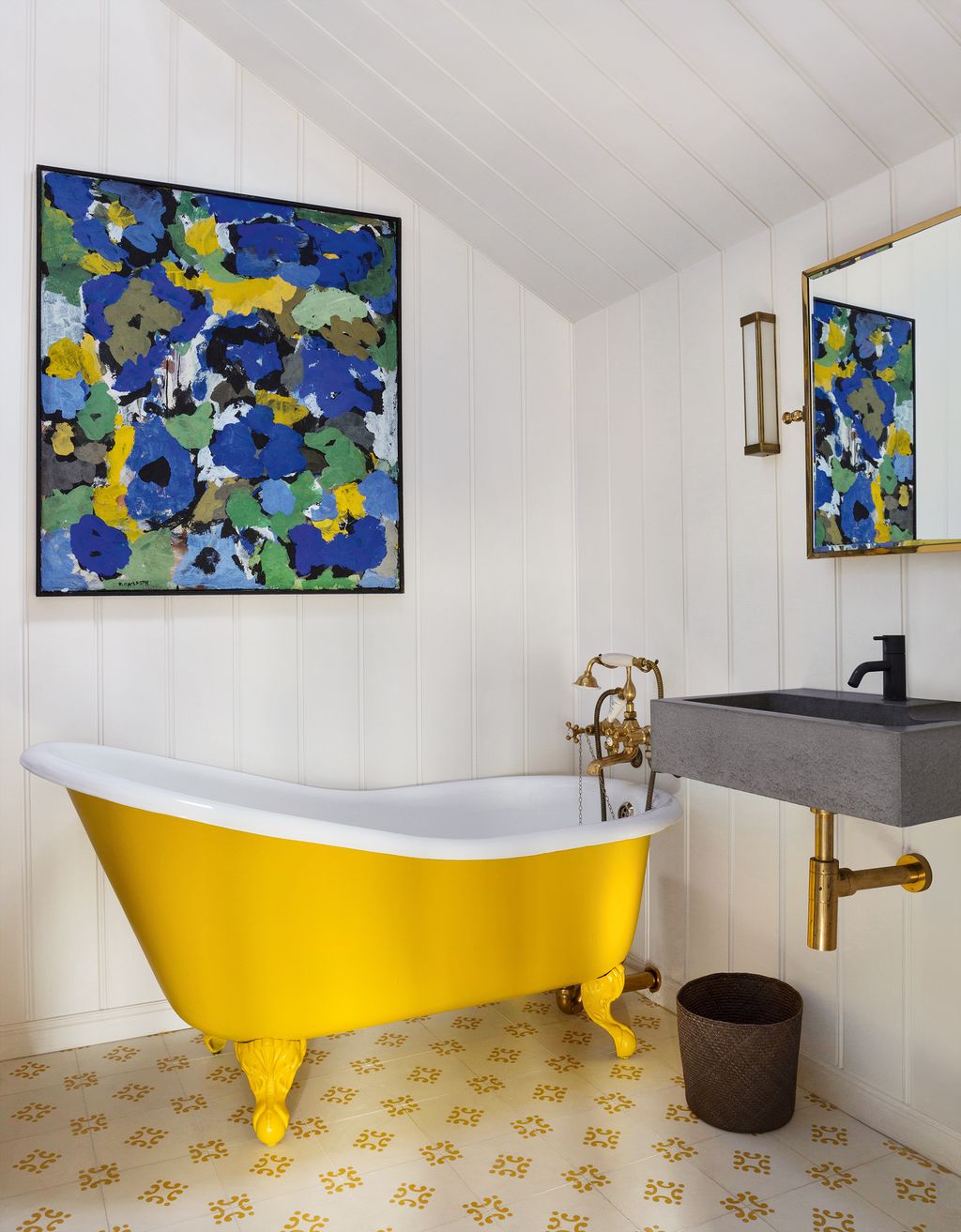 Stephan had the antique bath reenamelled in a bright yellow shade picked out by the floral painting above it and found...