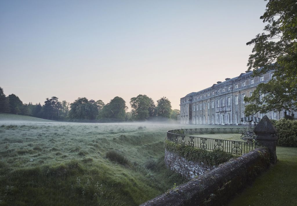 The west façade of Petworth House built in the late seventeenth century in local sandstone with Portland stone framing...