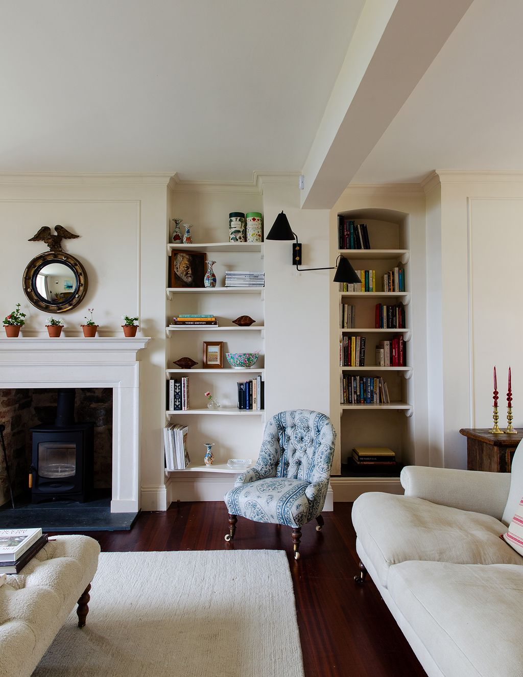 Image may contain Living Room Room Indoors Furniture Interior Design Couch Cushion Shelf and Fireplace