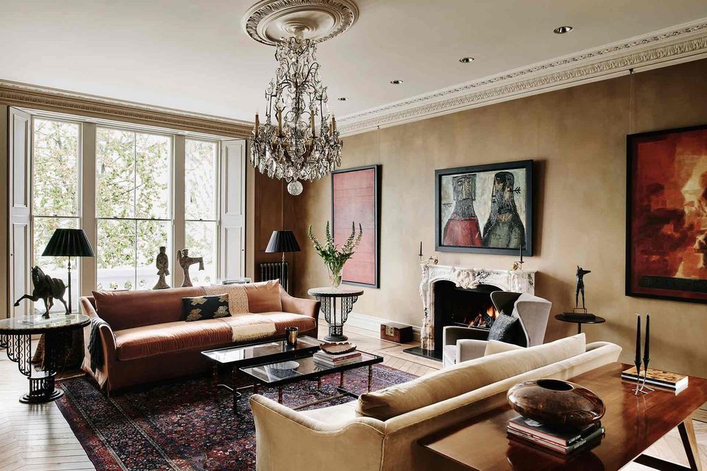 Image may contain Living Room Room Indoors Furniture Interior Design Couch Table Lamp Chandelier and Flooring