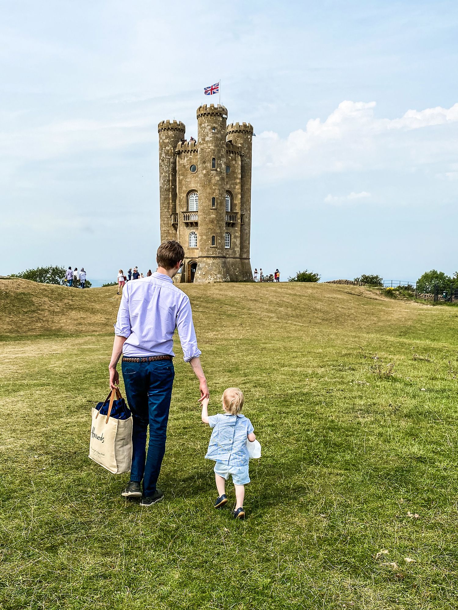 Image may contain Human Person Plant Grass Pants Clothing Apparel Architecture Building Castle Outdoors and Field